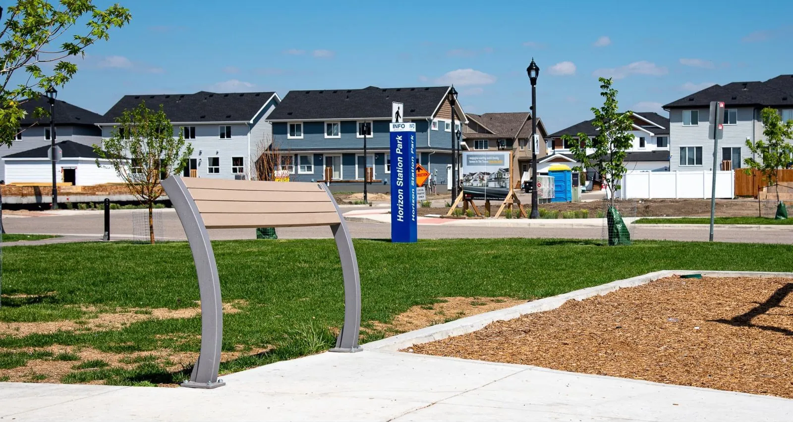 Parker Leaning Bench provides a place to rest in Horizon Station Park. The bench features recycled plastic lumber and a powder-coated metal frame.