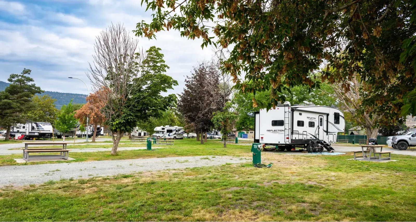 Picnic tables provide seating at Claybanks RV Park in Merritt, British Columbia. The tables offer a place to relax and enjoy the outdoors while camping.