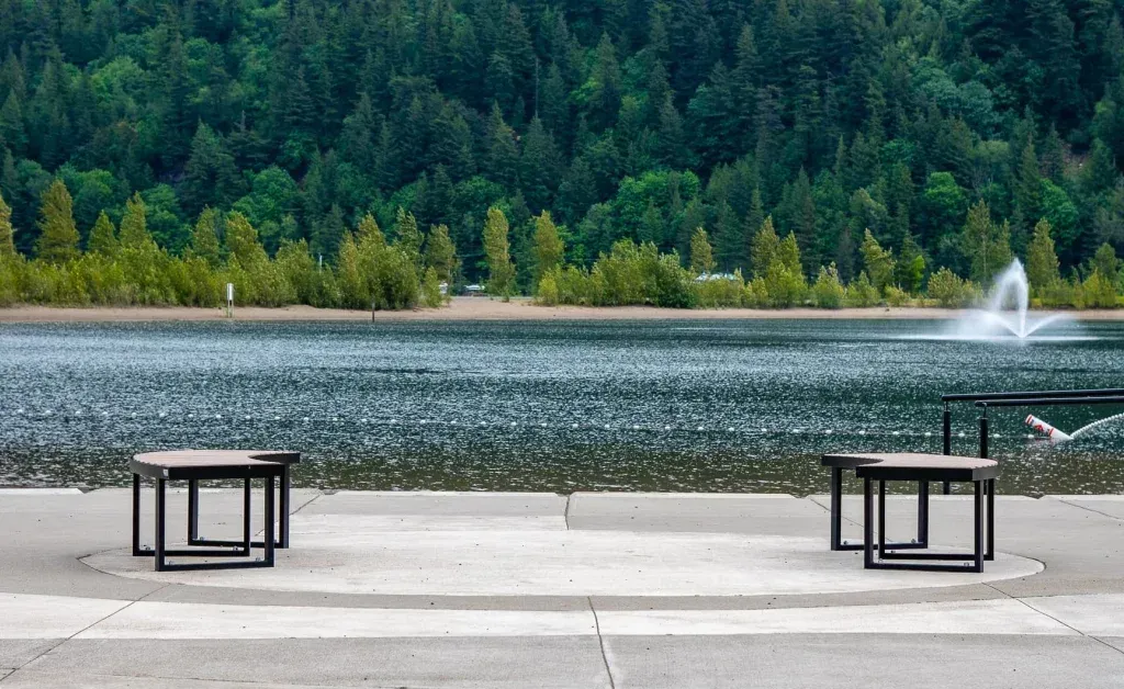 Skyline curved benches provide seating along the waterfront. The benches feature recycled plastic lumber and powder-coated metal frames, offering a durable and stylish seating solution.