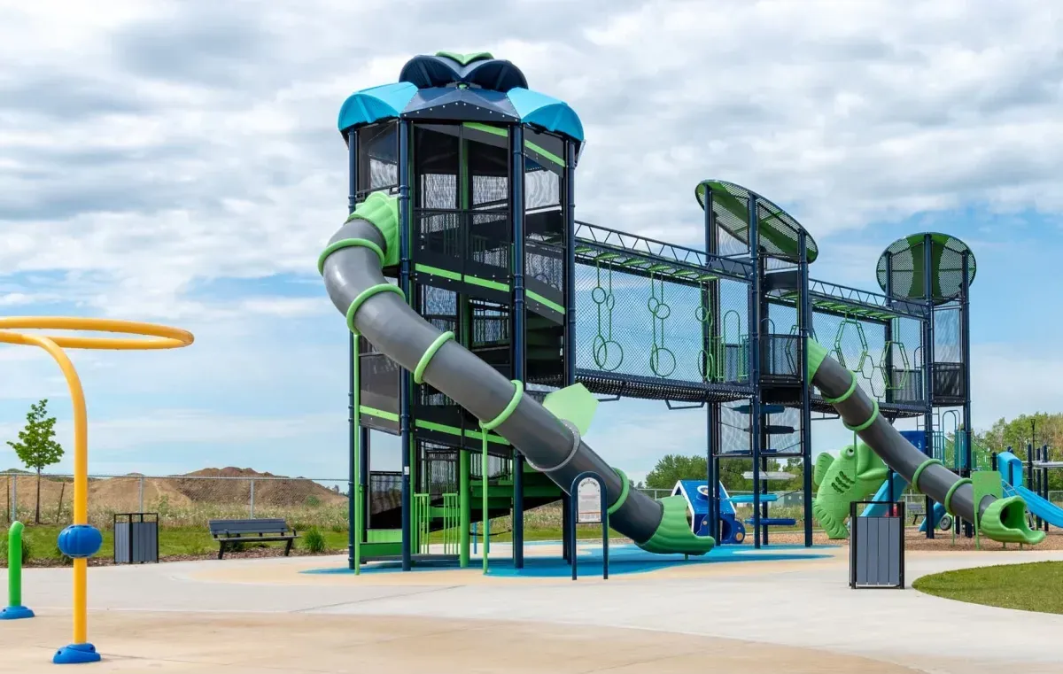Play structure with slides and climbing elements at the Co-operators Play Zone and Spray Park in Sylvan Lake, Alberta. The playground features a variety of colors and textures.