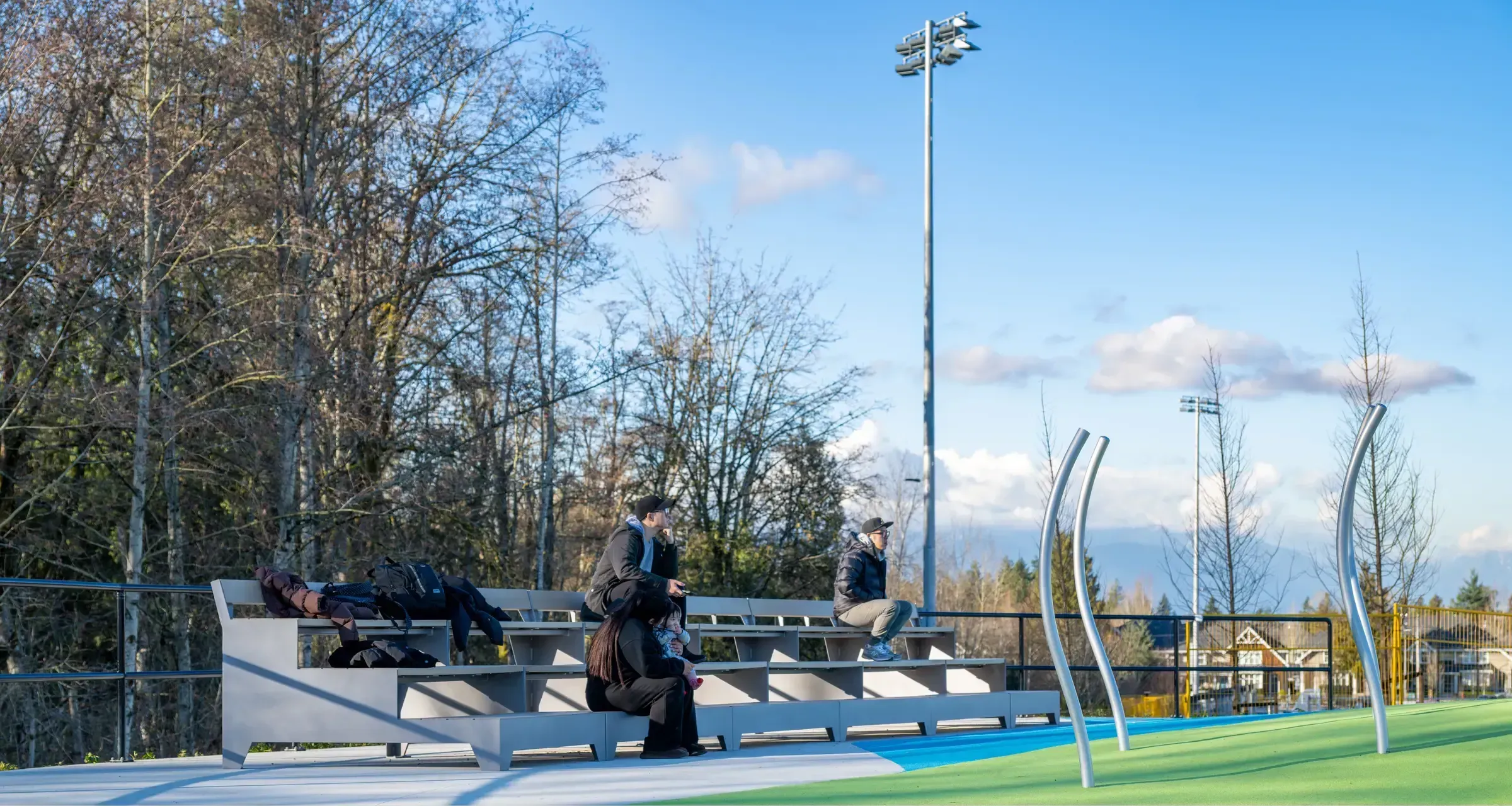 Multi-tiered step benches provide seating at Yorkson Community Park in Langley, British Columbia. The benches offer a place for spectators to relax and enjoy the view.