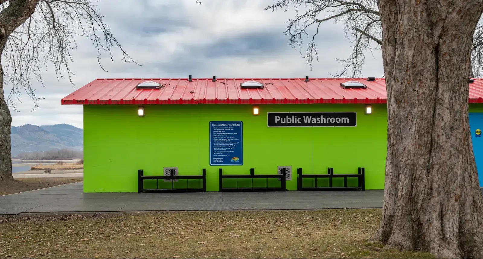 Backless benches with armrests and storage pockets are installed at Riverside Water Park. The benches provide seating for park visitors.