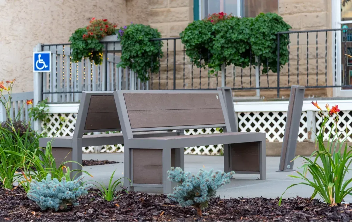 Urban Form Full Back benches provide comfortable seating in Sedgewick, Alberta. The benches feature recycled plastic lumber and a powder-coated metal frame.