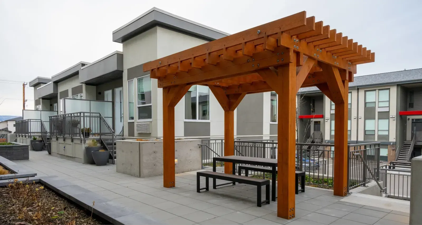Urban Form Harvest Picnic Table provides an inviting outdoor gathering space. The table features a durable design suitable for residential or commercial settings.