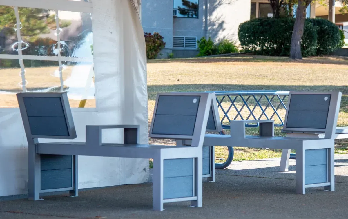 Urban Form Split Back Benches provide comfortable seating at Pacific Christian School in Saanich, British Columbia. The benches feature recycled plastic lumber and a powder-coated metal frame.