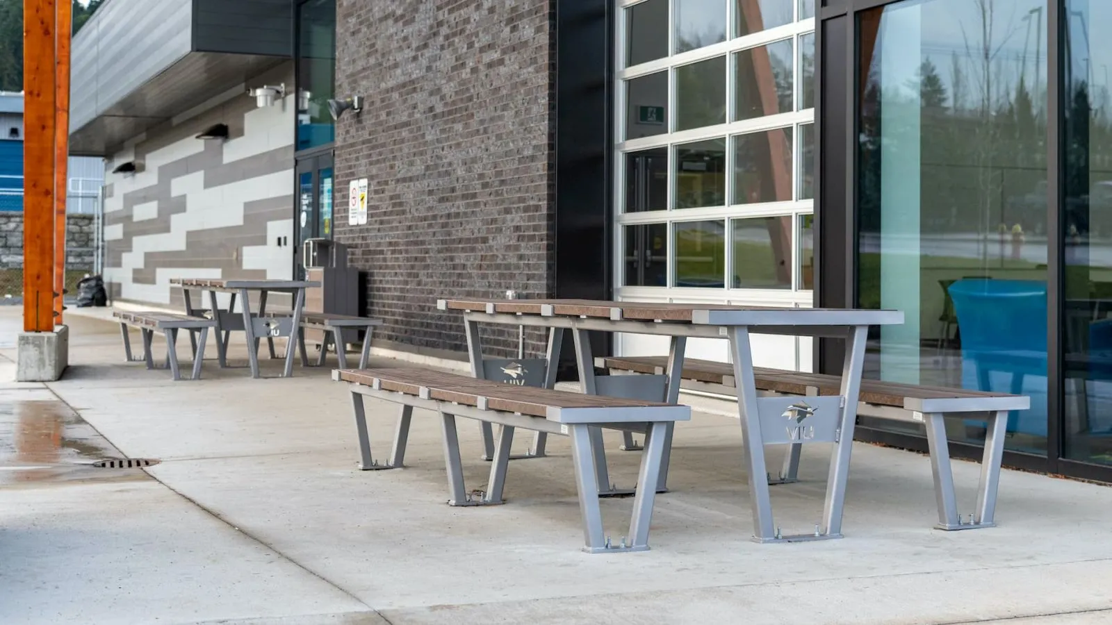 These Vincent picnic tables provide outdoor seating at Vancouver Island University. The tables feature recycled plastic lumber tops and powder-coated metal frames.