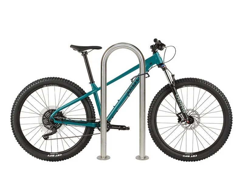 Bike parked at a stainless steel loop bike rack. The simple and durable rack provides secure bicycle parking.