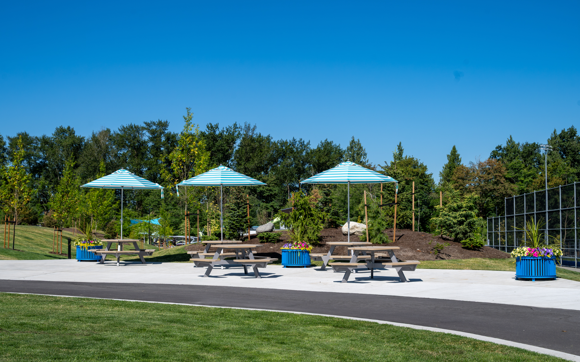 Wishbone Beselt Round Self Watering Planters and Bayview Hexagonal Picnic Tables at Yorkson Community Park in the Township of Langley