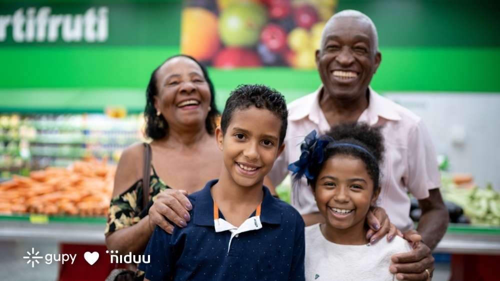 Família de consumidores feliz fazendo compras no supermercado