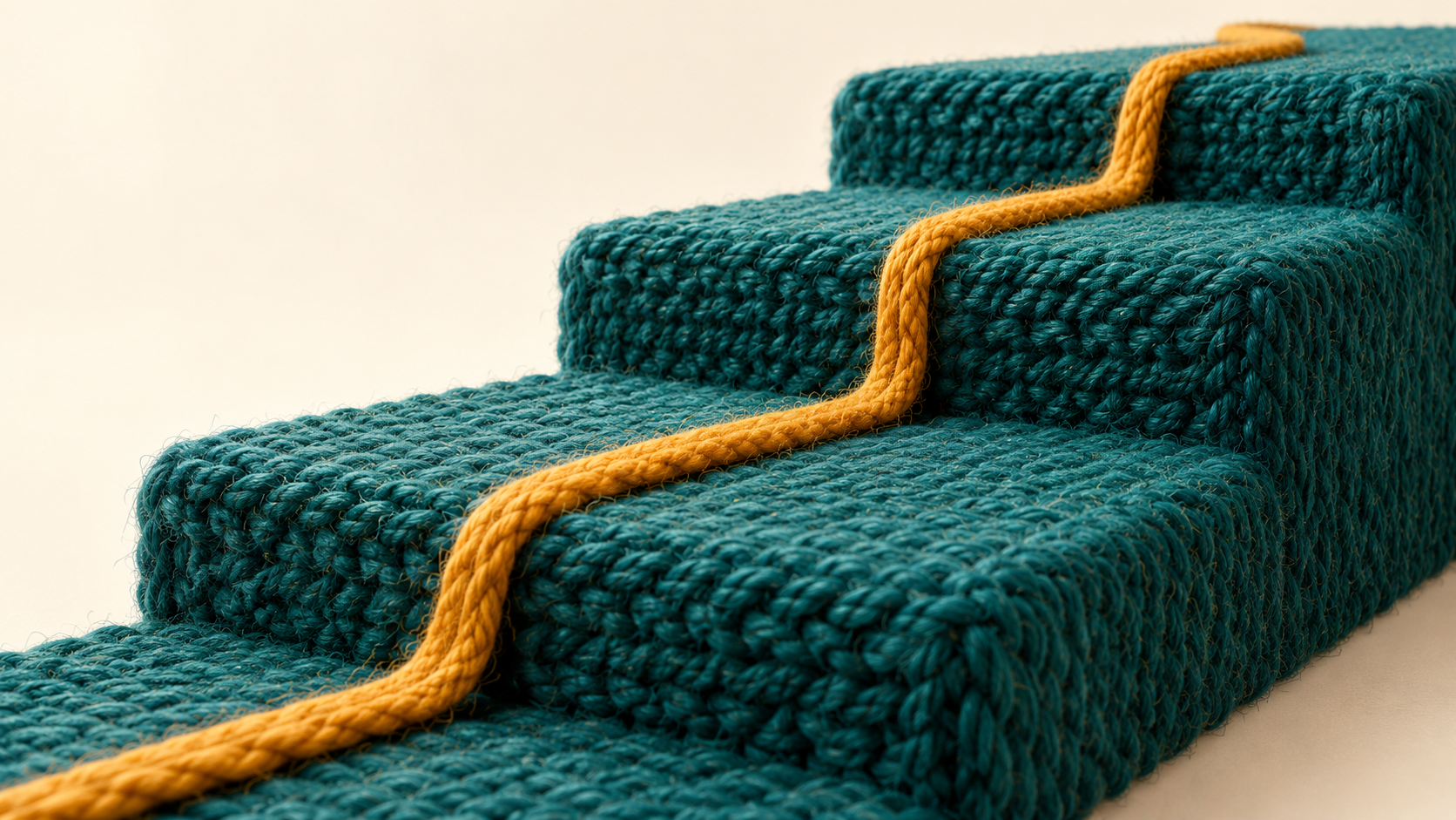 An ochre thread follows three ascending terraces made from woven teal wool.