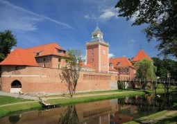 Photo of the castle with a visible moat