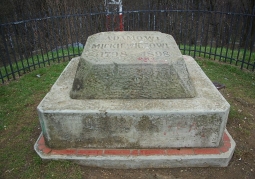 Stone with an inscription at the top of the mound