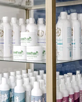 Brand photo example: hair and scalp care products on glass shelves in a gold-framed display