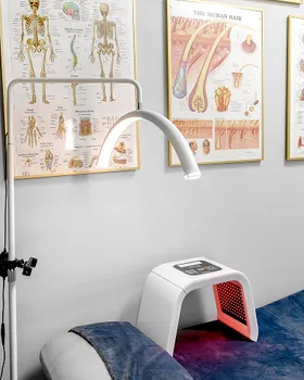 Brand photo example: clinical treatment room with anatomy charts and LED therapy equipment