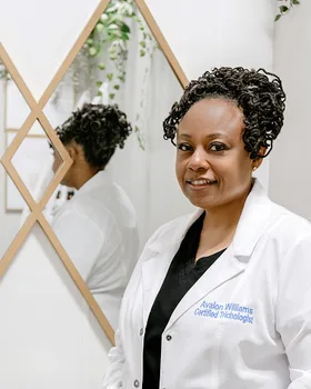 Brand photo example: certified trichologist portrait in a bright clinic with mirror reflection