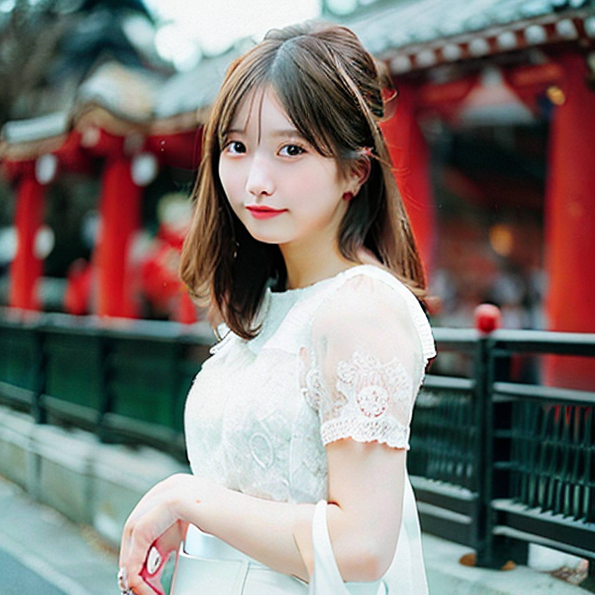 a young woman in a red dress posing for a picture 