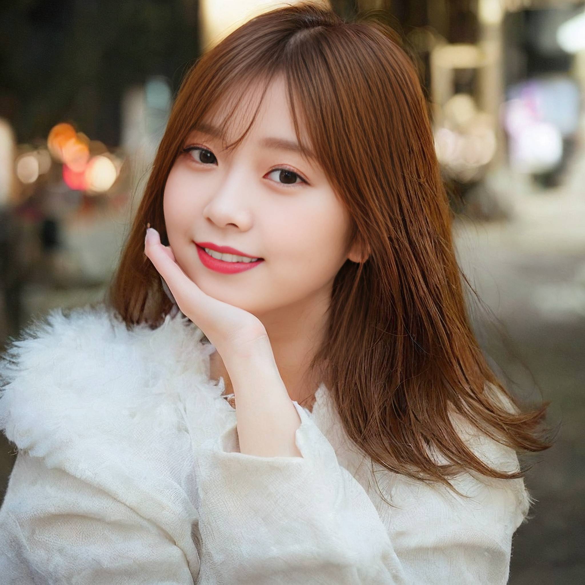 a woman in a white dress holding a white object 