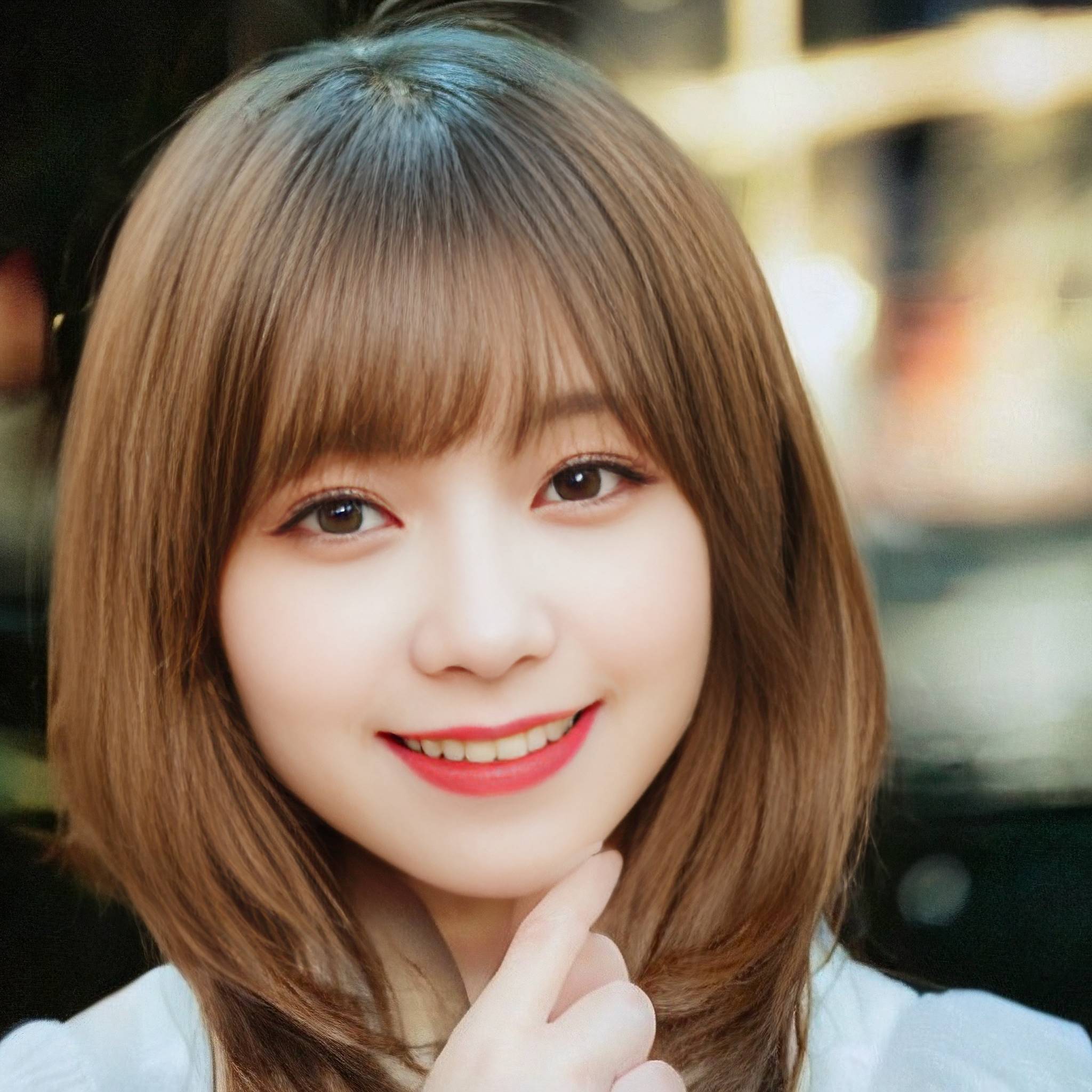 a woman in a red dress smiling at the camera 