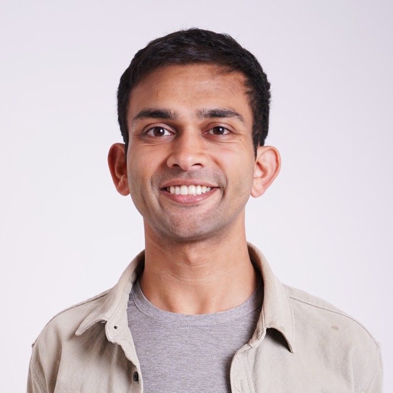 Dhruv Amin, co-founder and co-CEO of Anything, seated outdoors in San Francisco