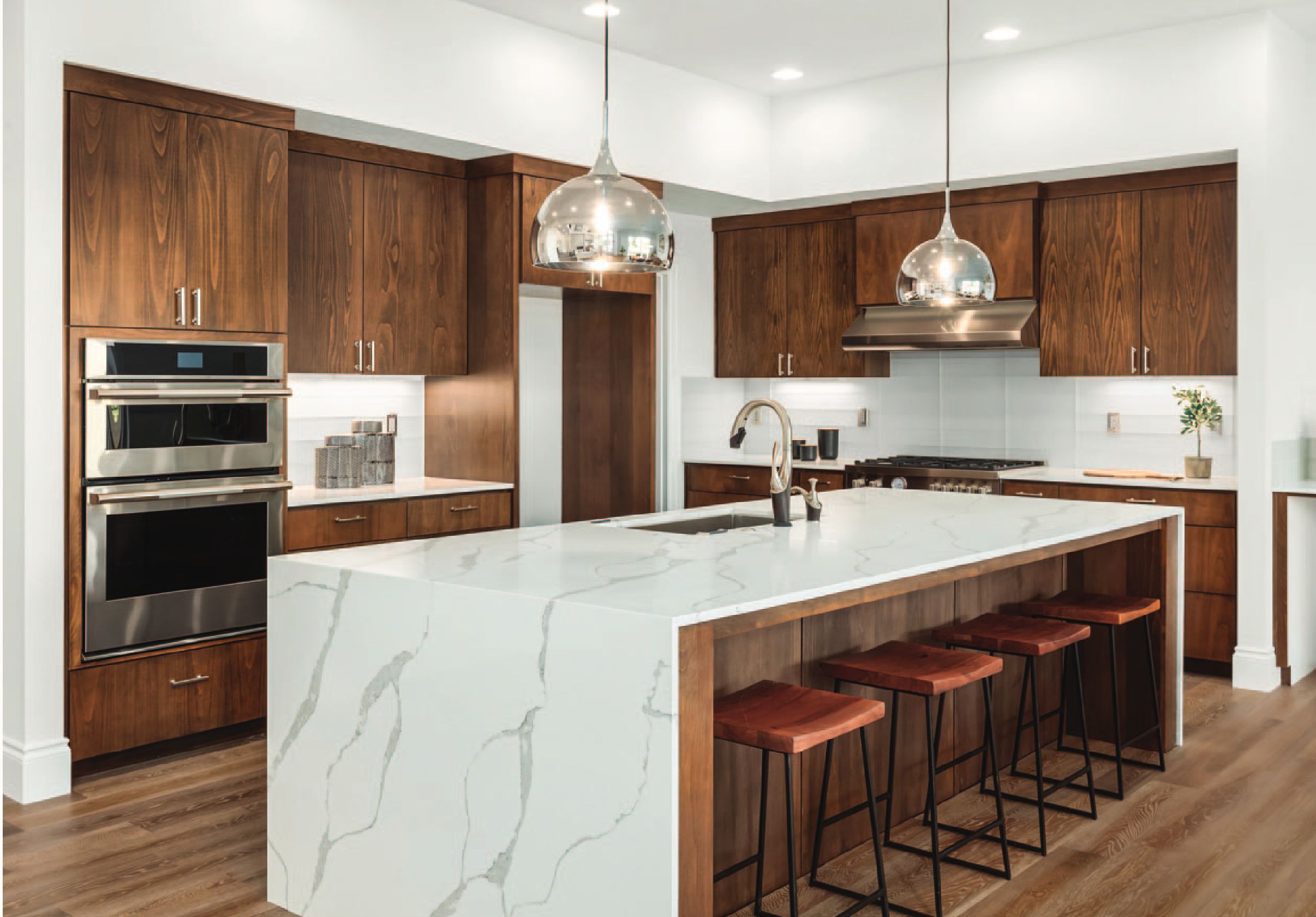 A kitchen with wooden cabinets and a marble island