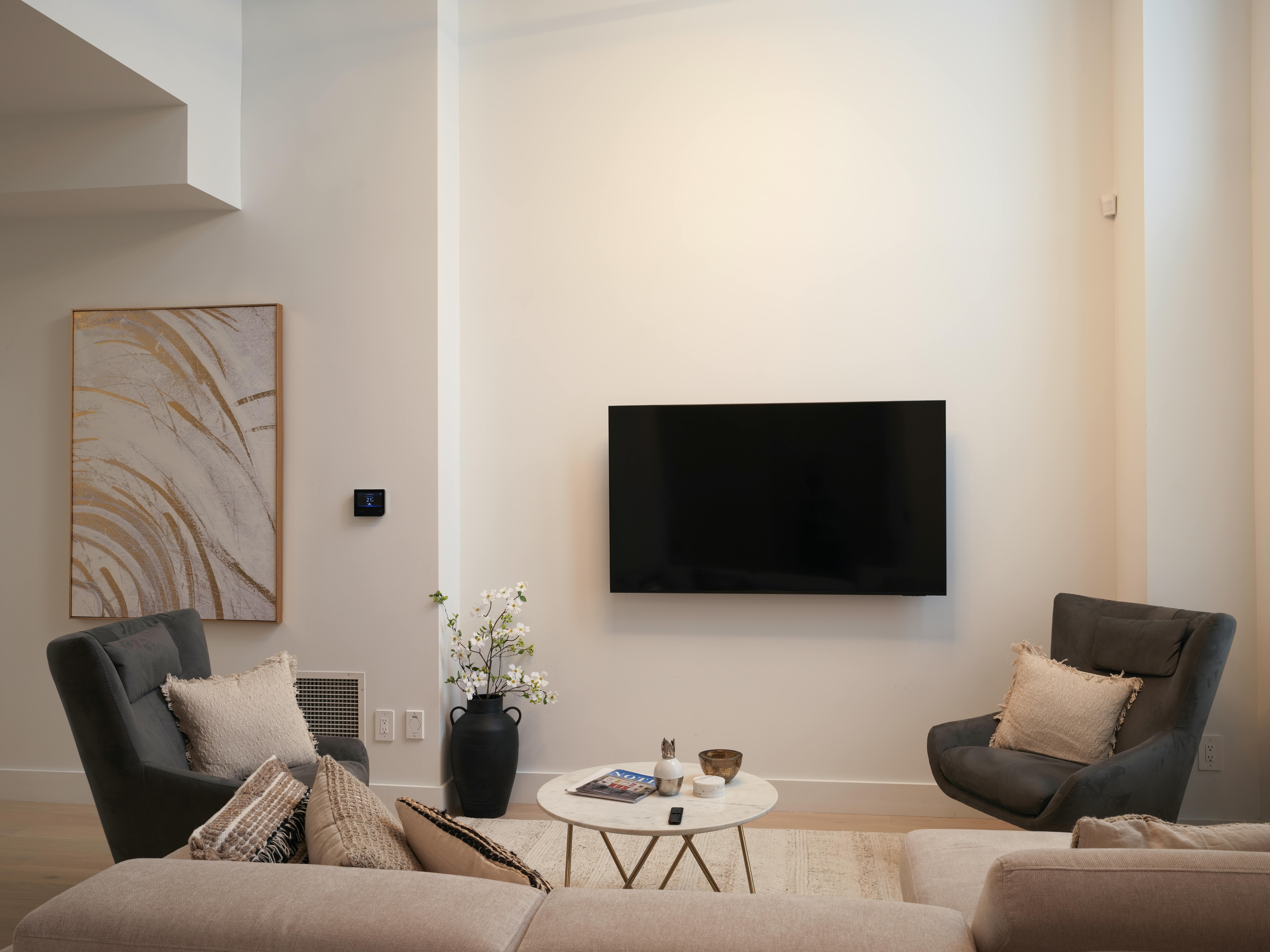 An elegant, modern living room that blends historical architecture with contemporary cooling solutions, capturing the unique challenge of retrofitting