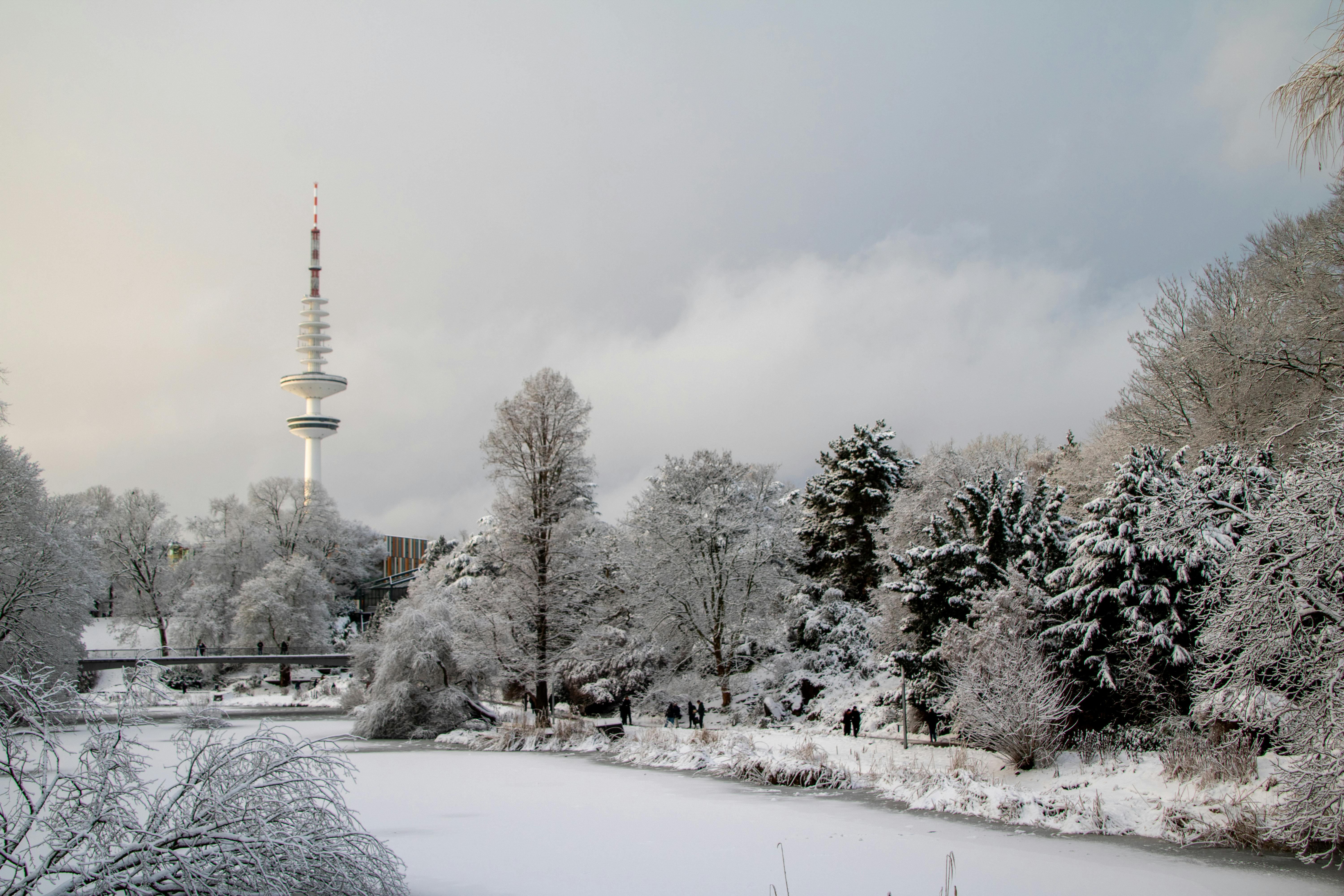 A picturesque view of a newly constructed sunroom addition to a home, featuring large glass windows with views of a snowy landscape, typical of the Le