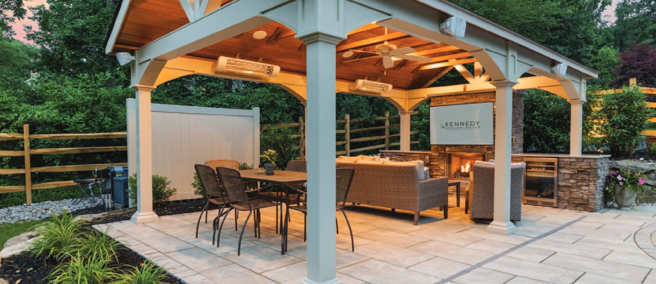 A luxury outdoor pavilion with seating and a fireplace.