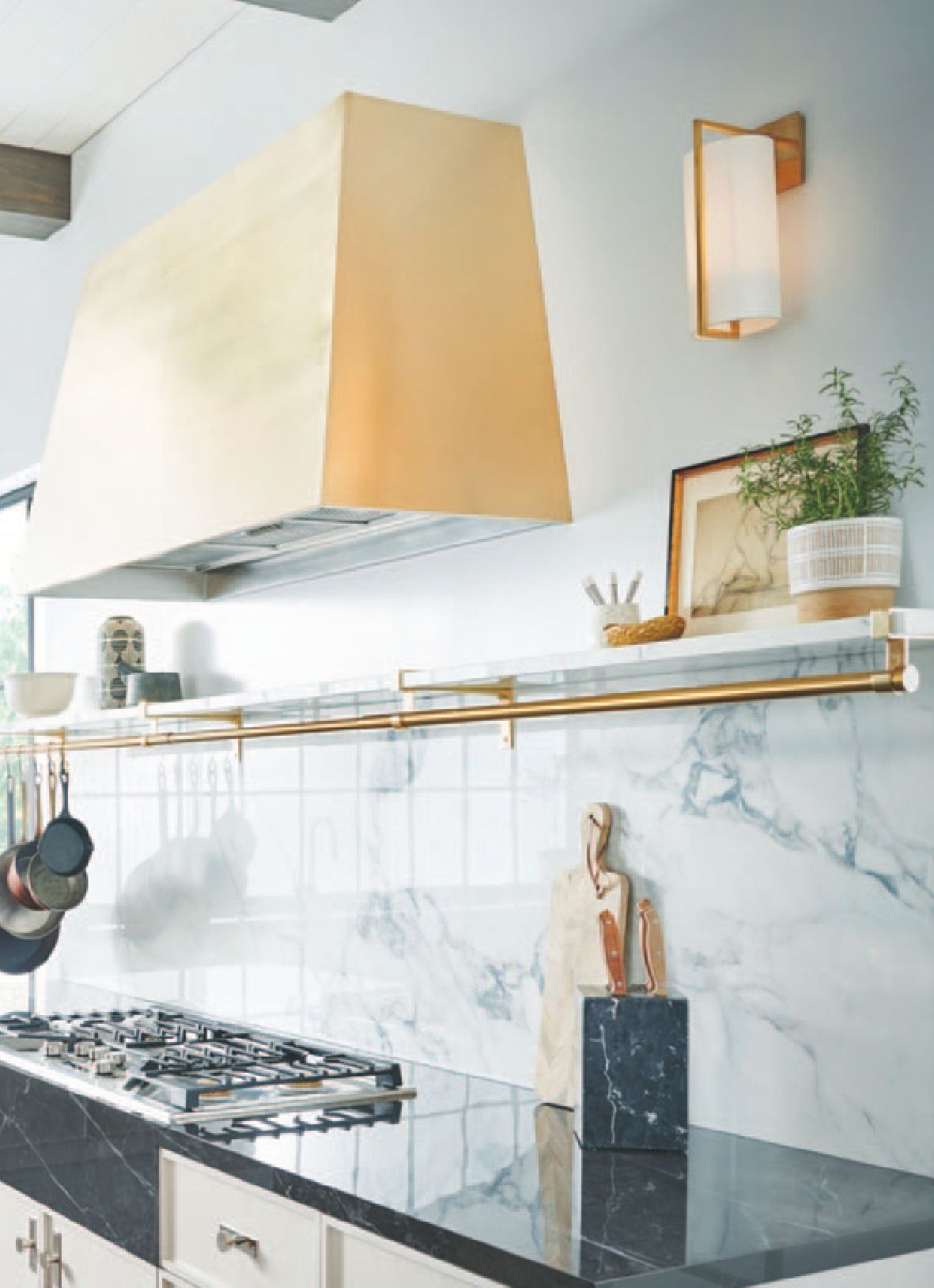 Modern kitchen with gold accents and marble backsplash