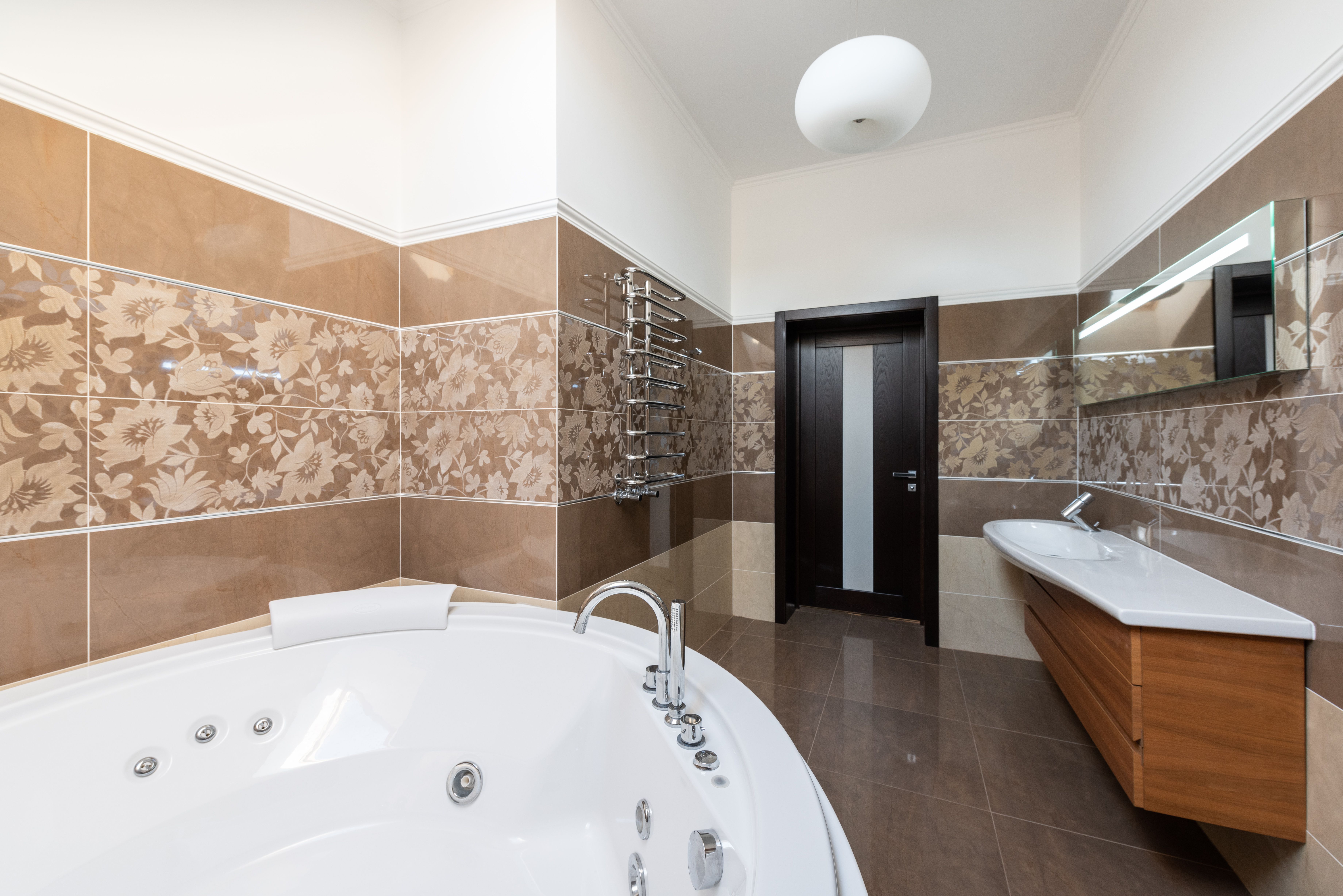 A dehumidifier placed in a bathroom corner, actively reducing moisture levels, with a focus on its integration with the room's ventilation system, in 