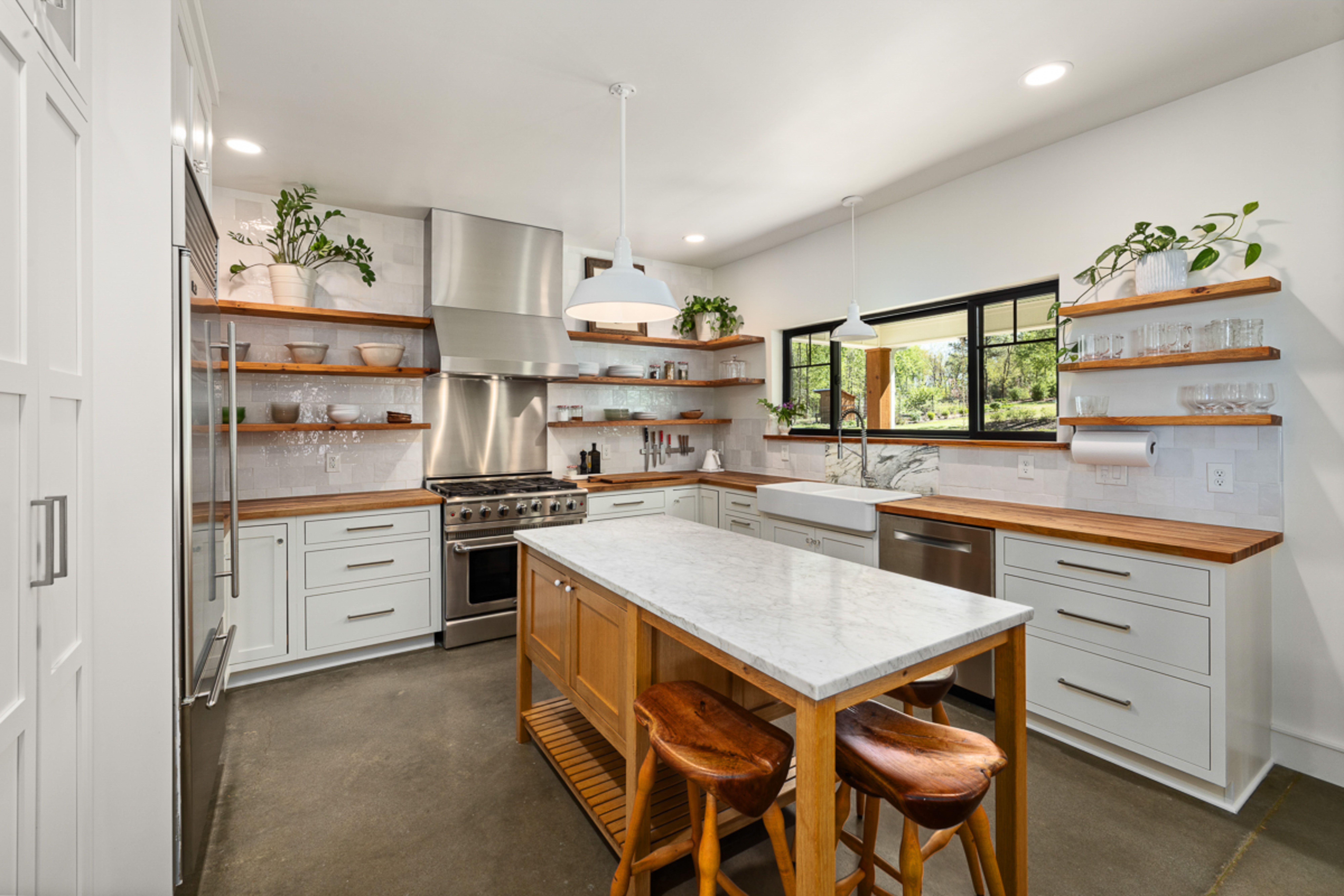 Close-up of different weather-resistant outdoor kitchen countertops, including granite, stainless steel, and porcelain, with droplets of water to symb
