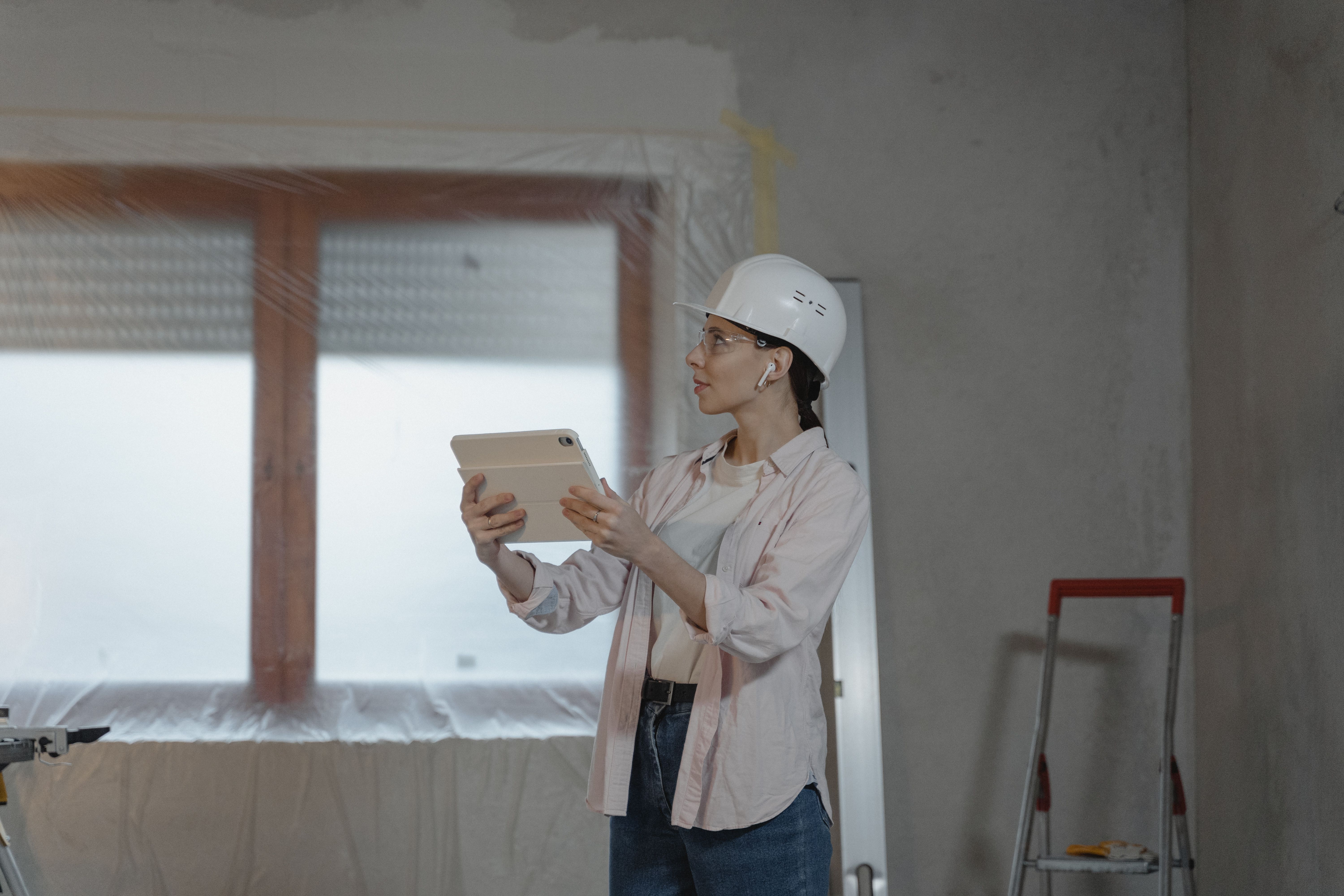 A professional handyman inspecting an attic with eco-friendly insulation materials. The scene captures the importance of professional assessment and i