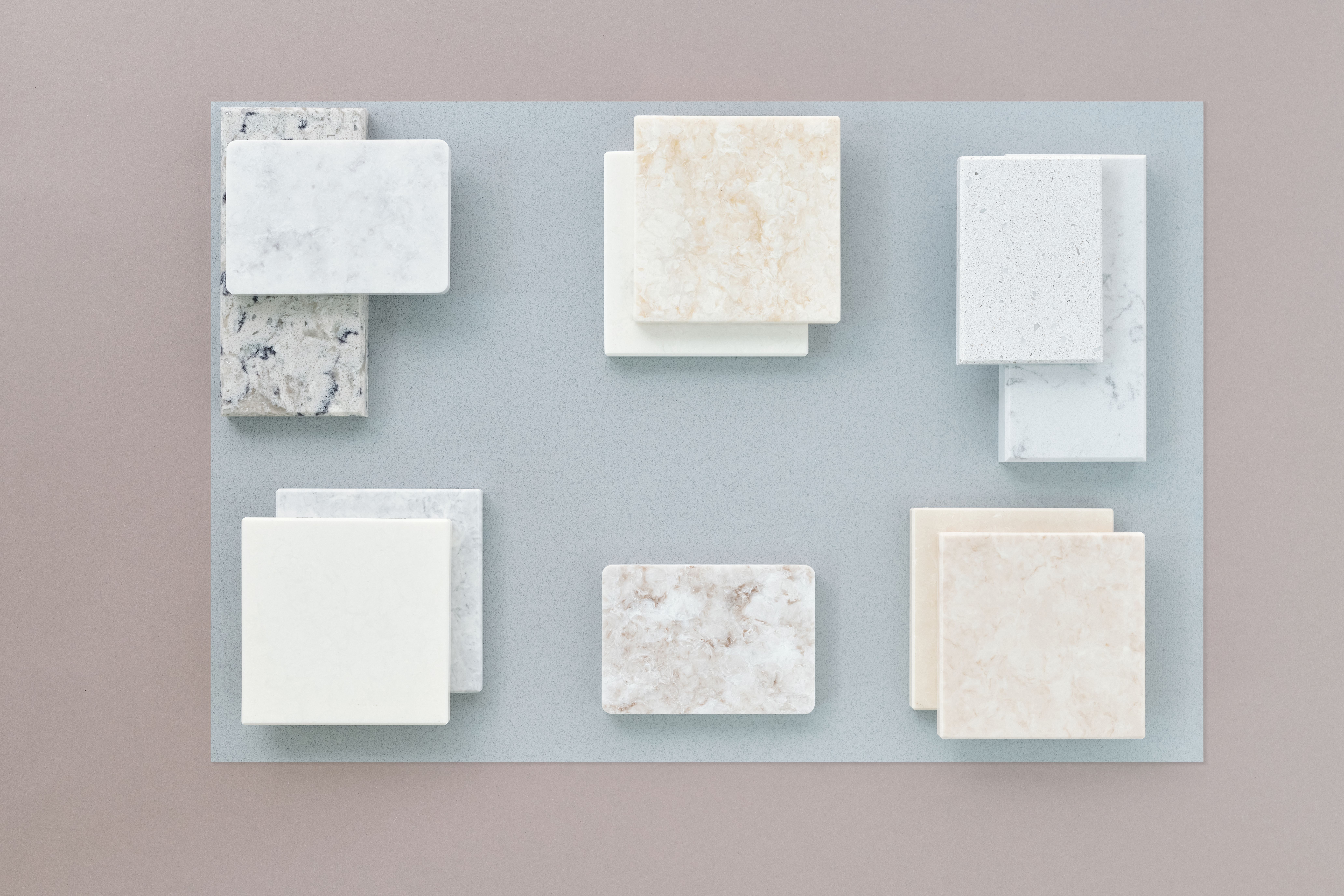 A comparison image showing the aesthetic variety of LVP flooring, with samples mimicking different materials such as wood, stone, and tiles, laid out 