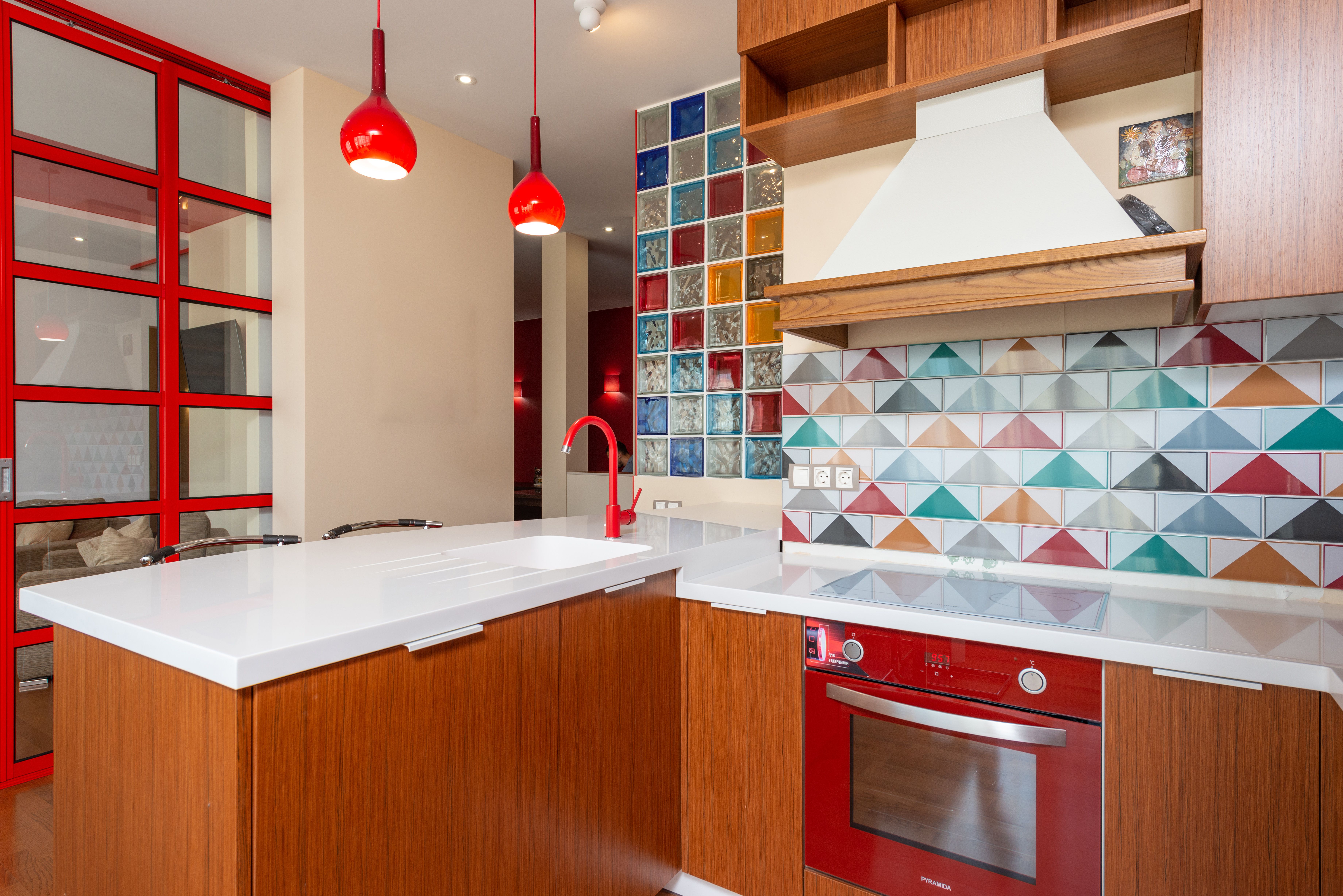 A vibrant and colorful kitchen backsplash with bold patterns that make a statement, set in a modern kitchen environment to show its impact on the over