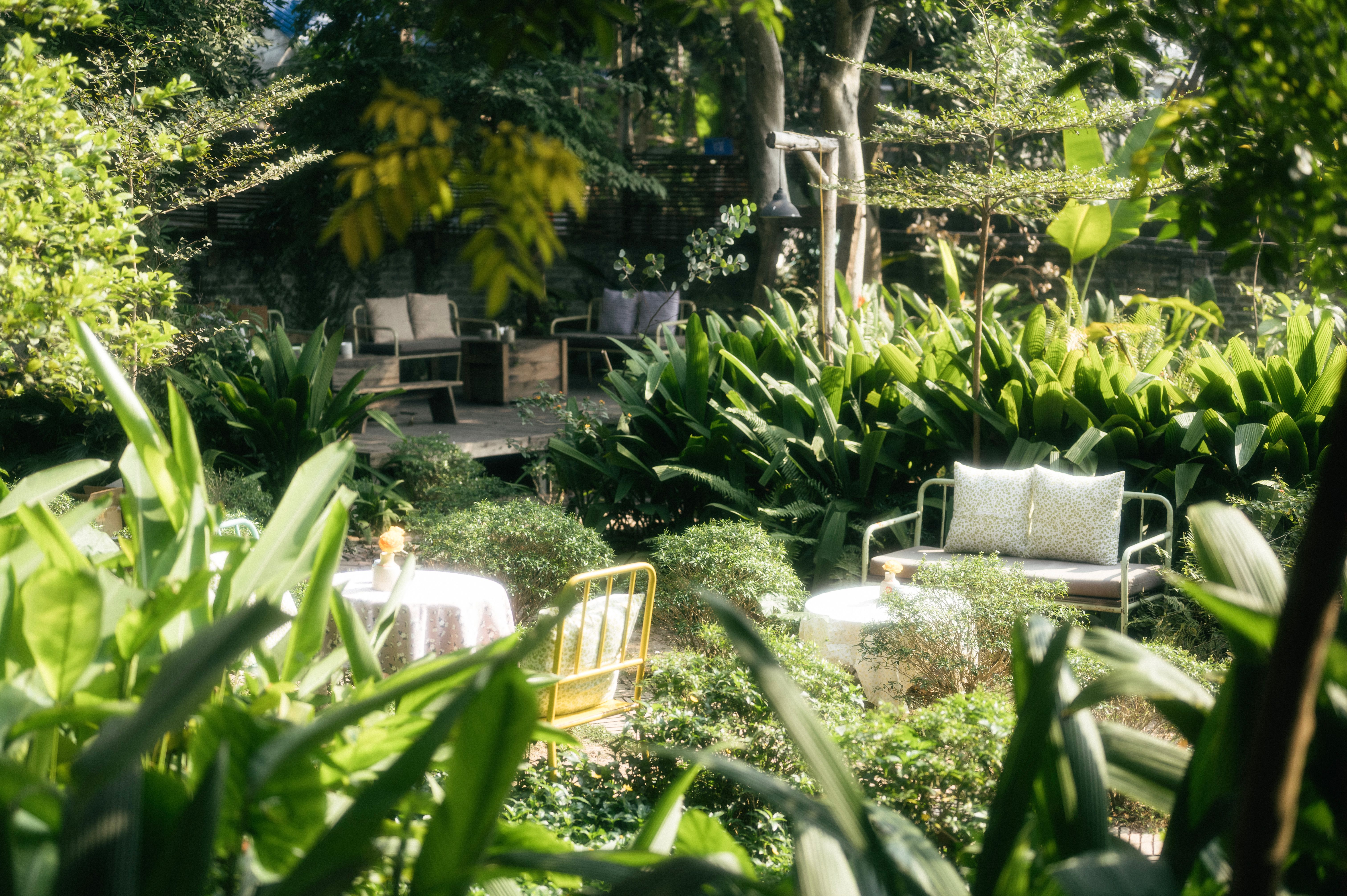 A sustainable garden featuring native plants, eco-friendly hardscaping materials like recycled pavers, and a small water feature. The garden is design