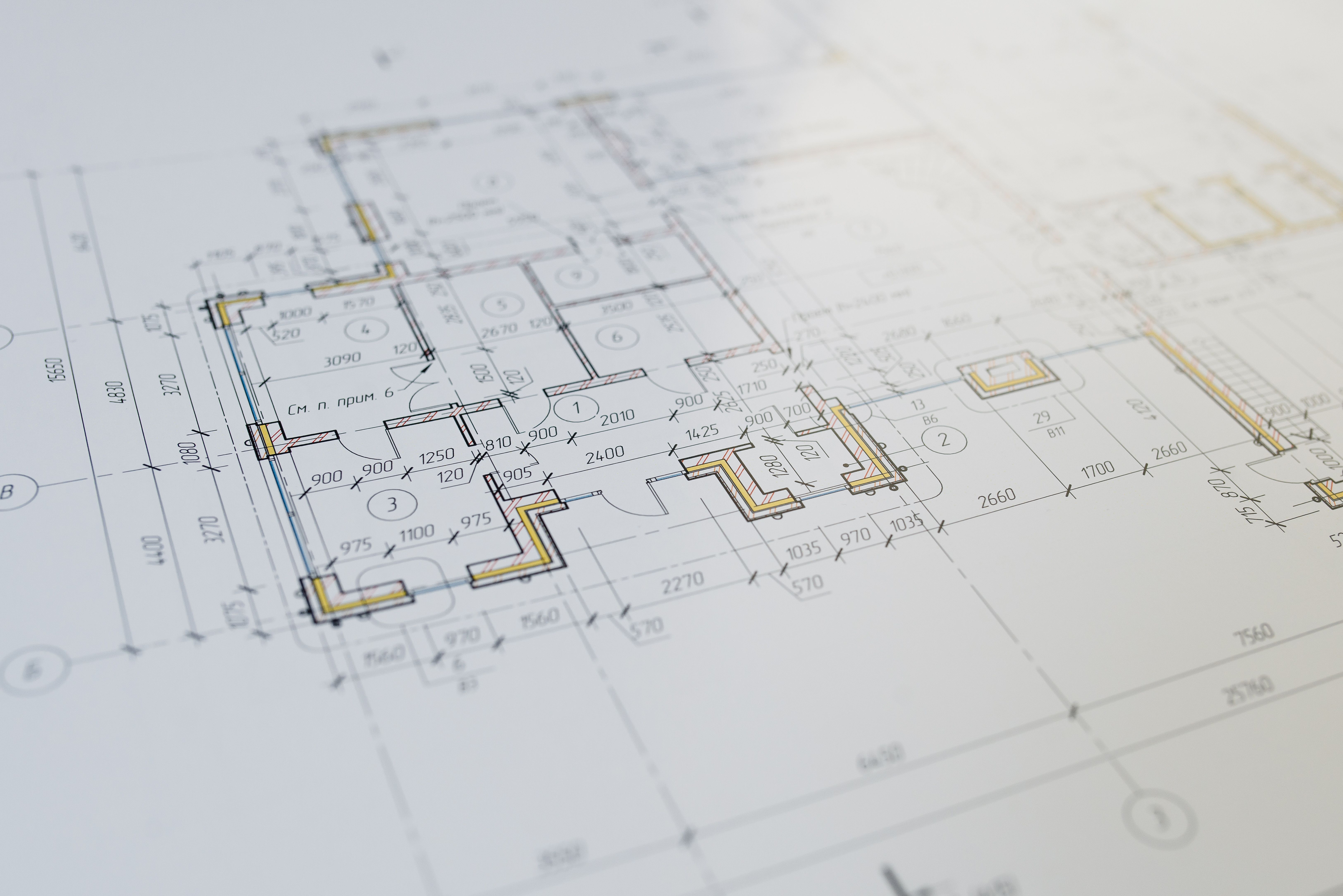 A detailed landscape design blueprint, showing a mix of hardscaping elements like patios, walkways, and retaining walls. The plan includes a variety o