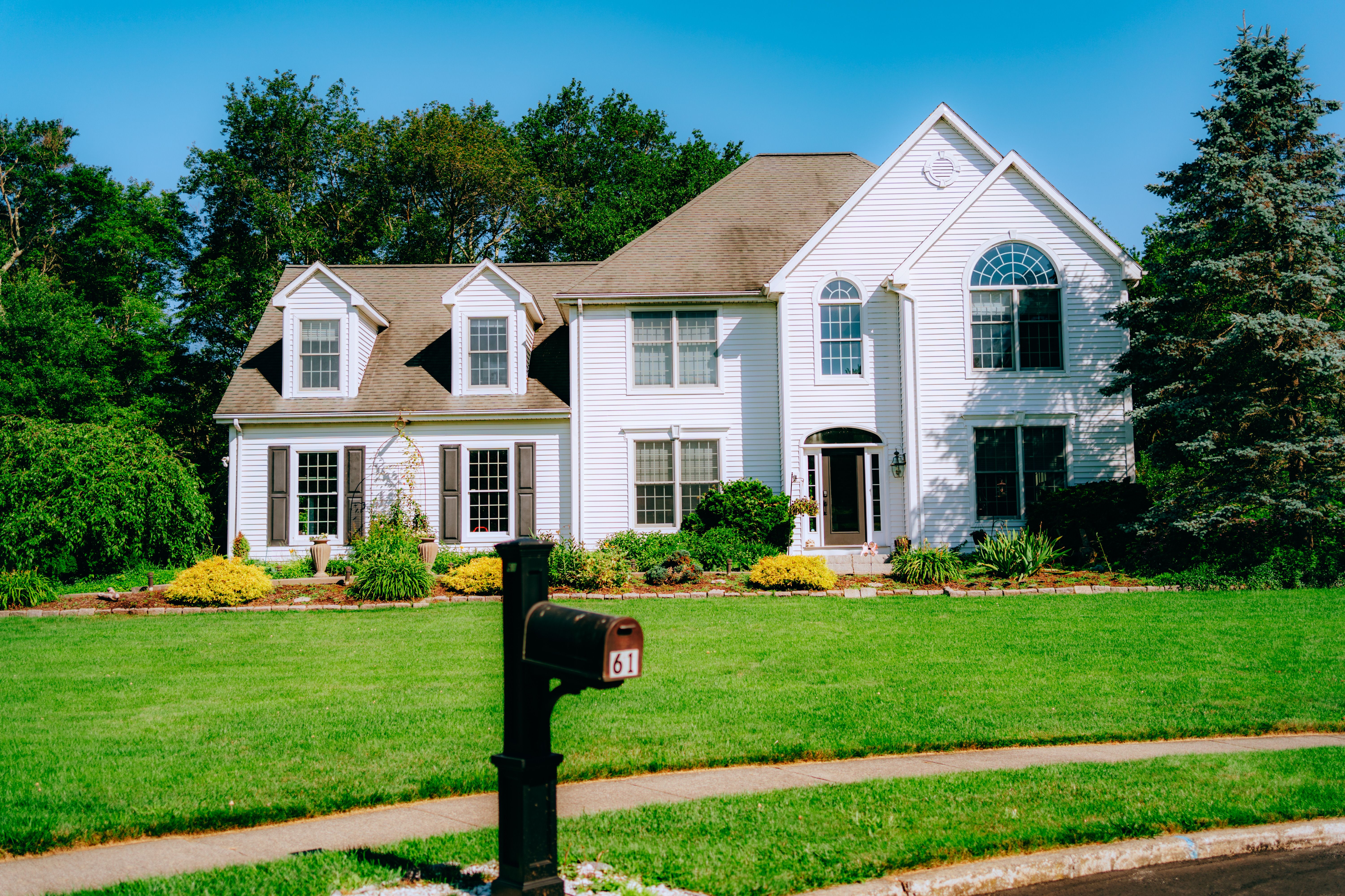 A scenic view of a traditional Colonial style home in the Lehigh Valley, with a focus on architectural details and materials that are typical for the 