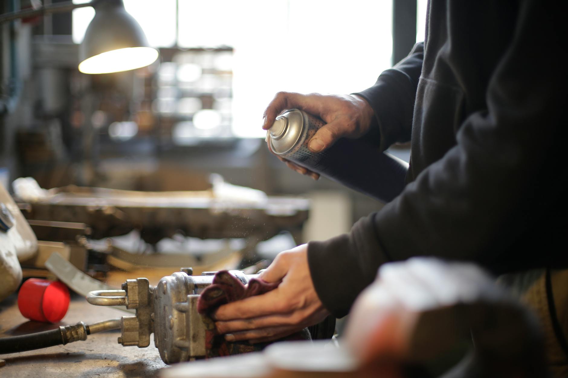 An HVAC technician inspecting or repairing a furnace to ensure optimal home heating system performance.