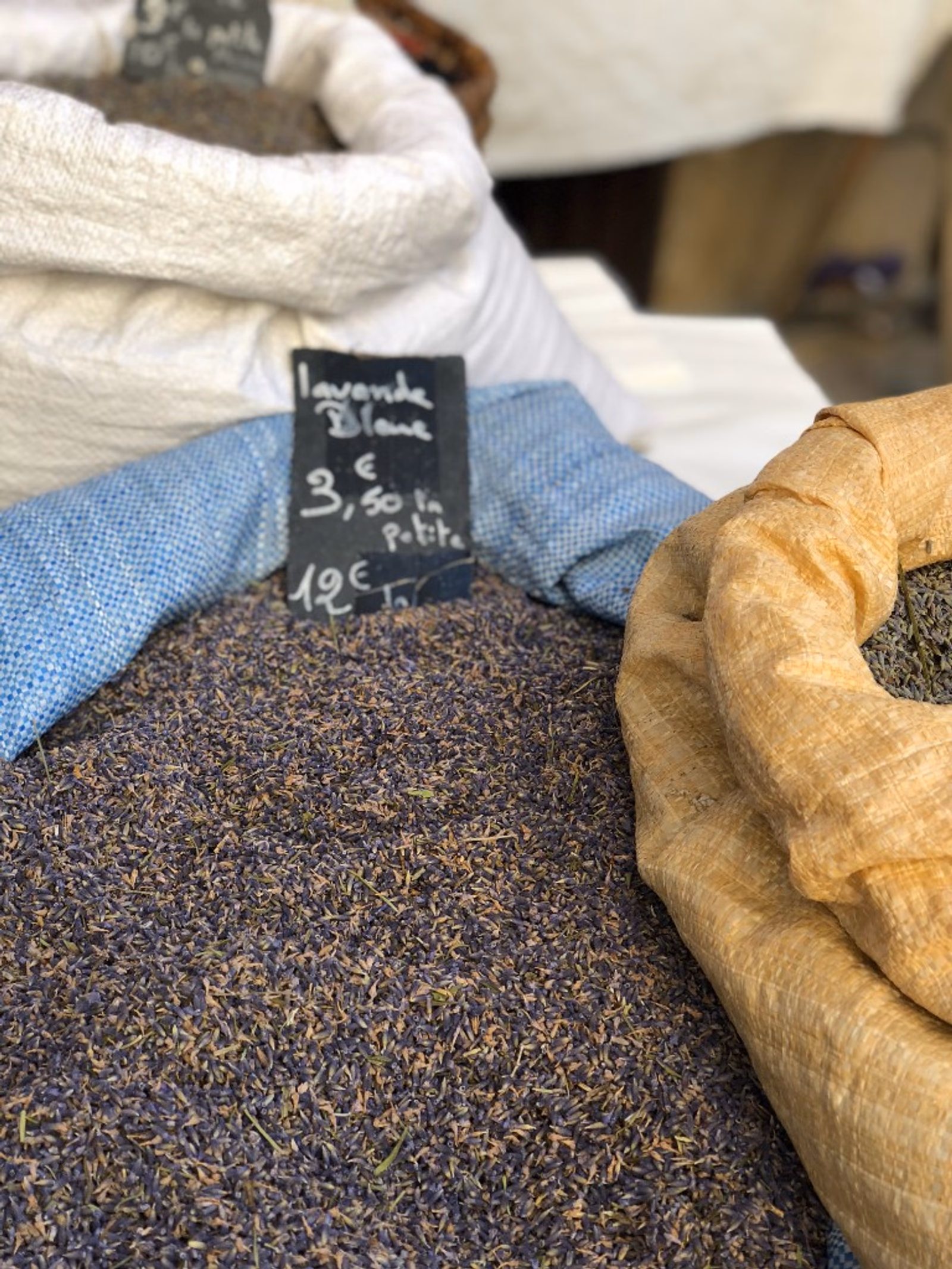 Dried lavender buds in woven sacks at a Provençal market