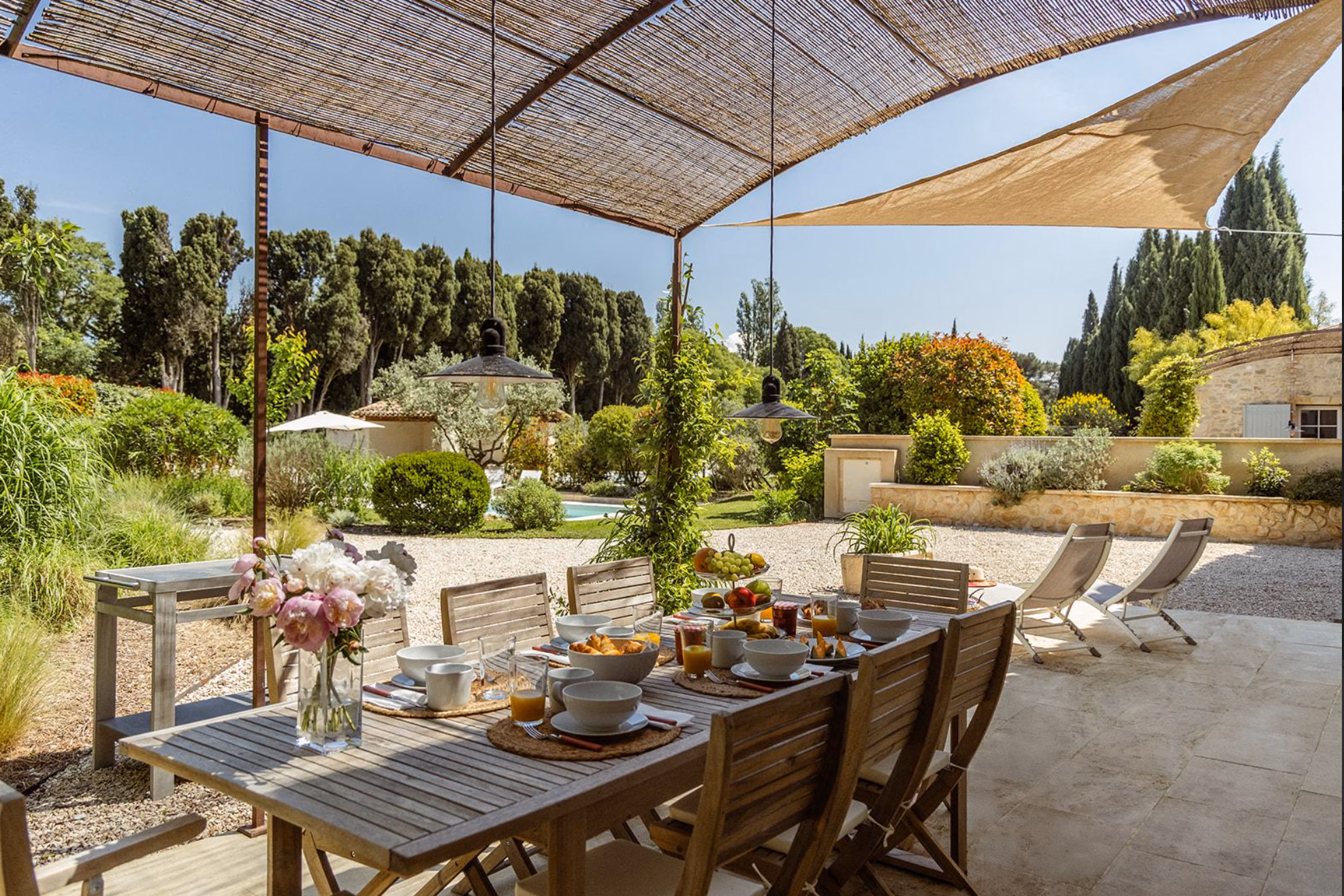 Outdoor breakfast table under a pergola at Mas Millésime