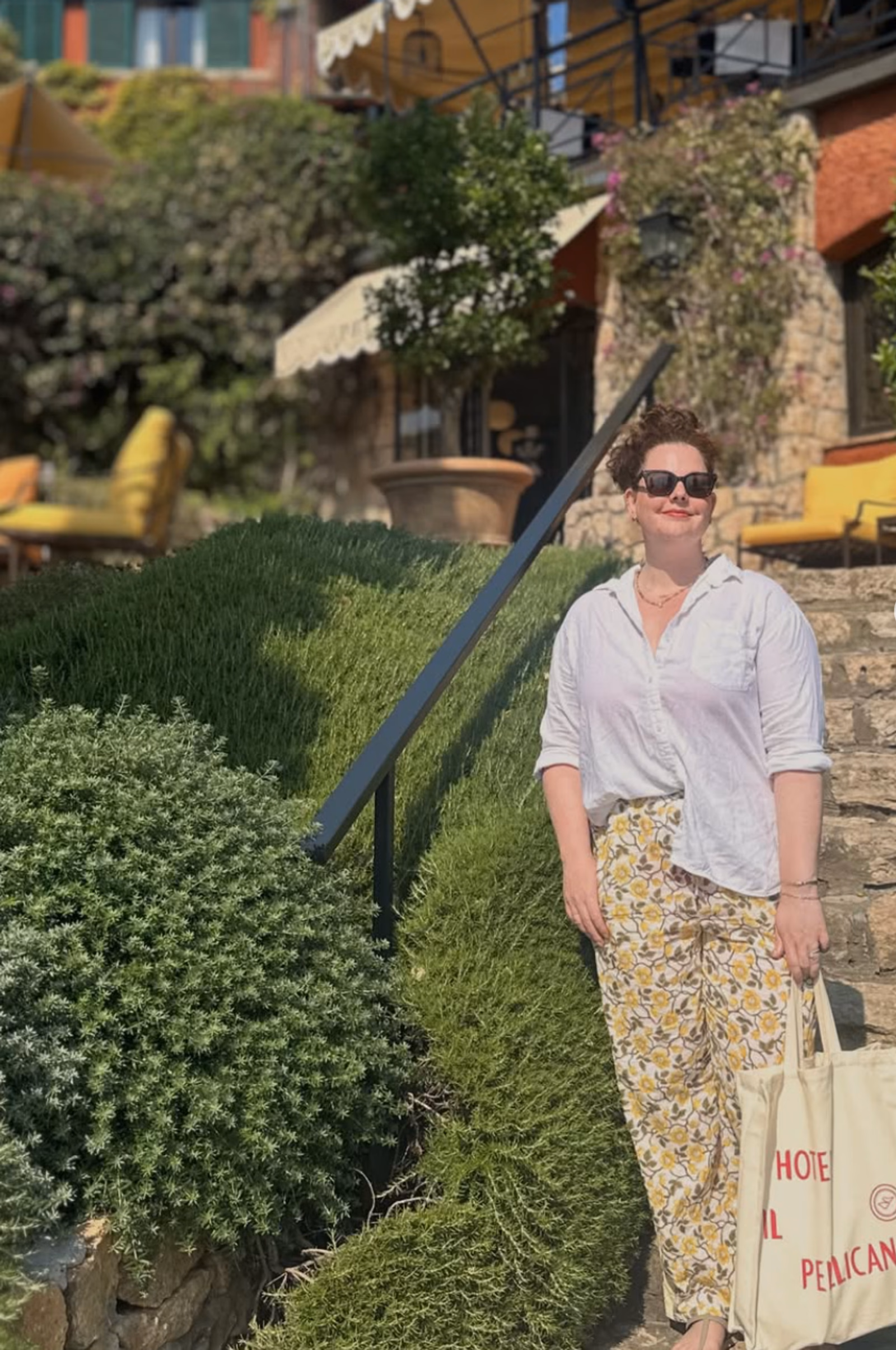 Elise relaxing in a pool at a sun-drenched villa terrace