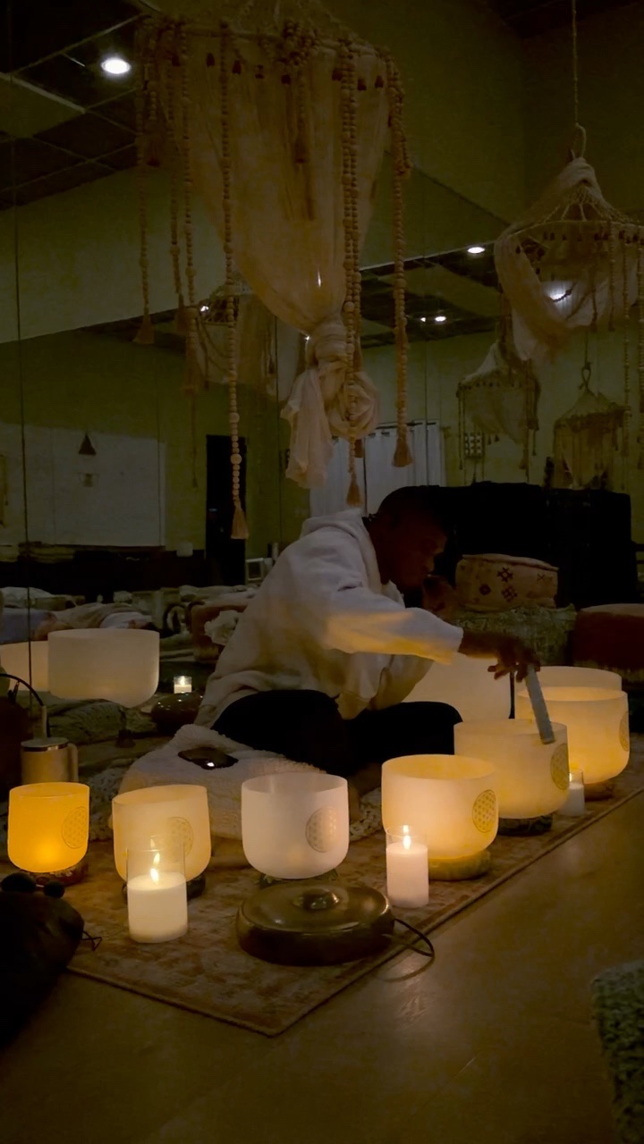 Cameron leading a candlelit sound bath