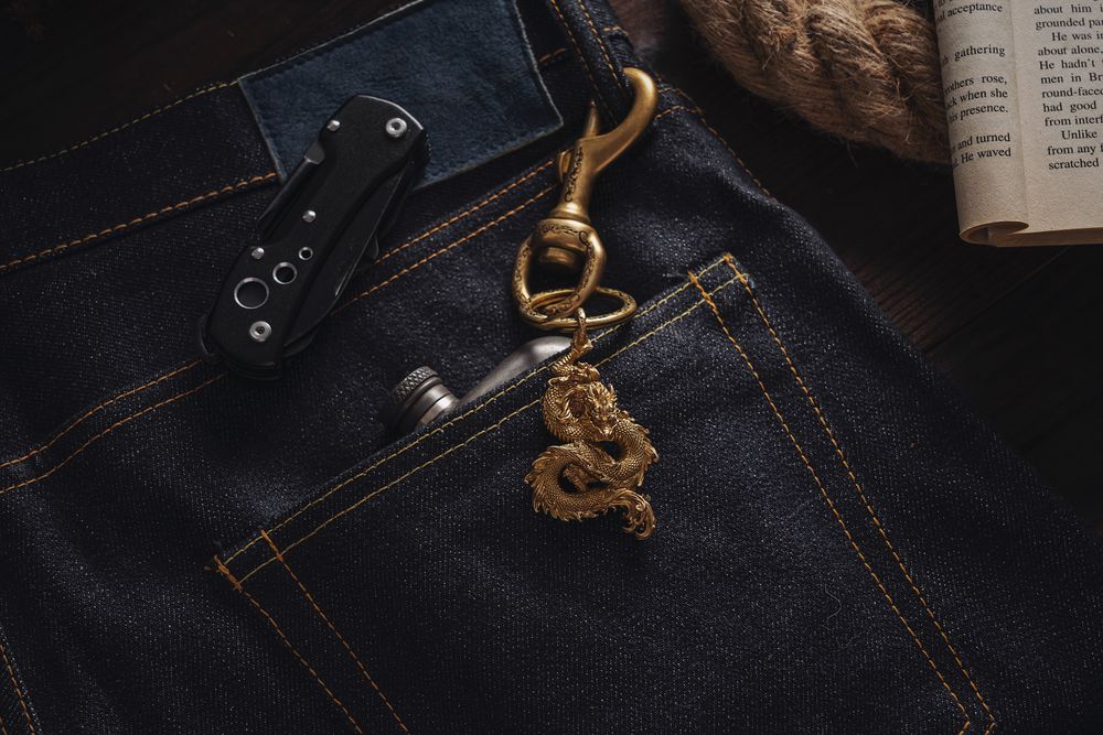 Folding knife handle peeking out of a denim pocket