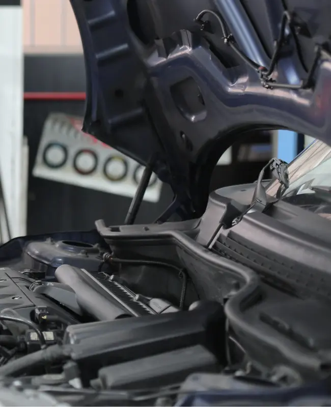 Truck with its hood raised exposing its engine compartment