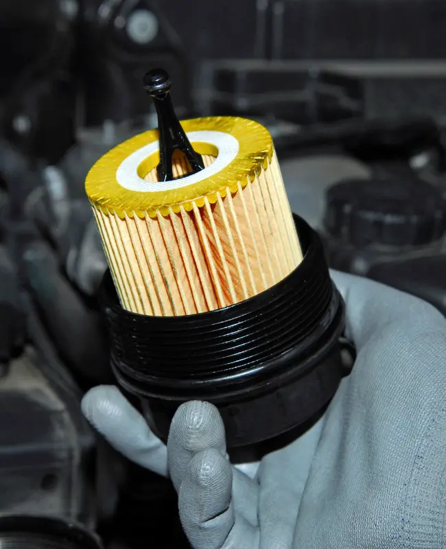 Mechanic holding an automotive oil filter