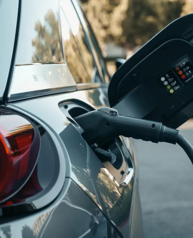 Electric vehicle charging at a battery charging station
