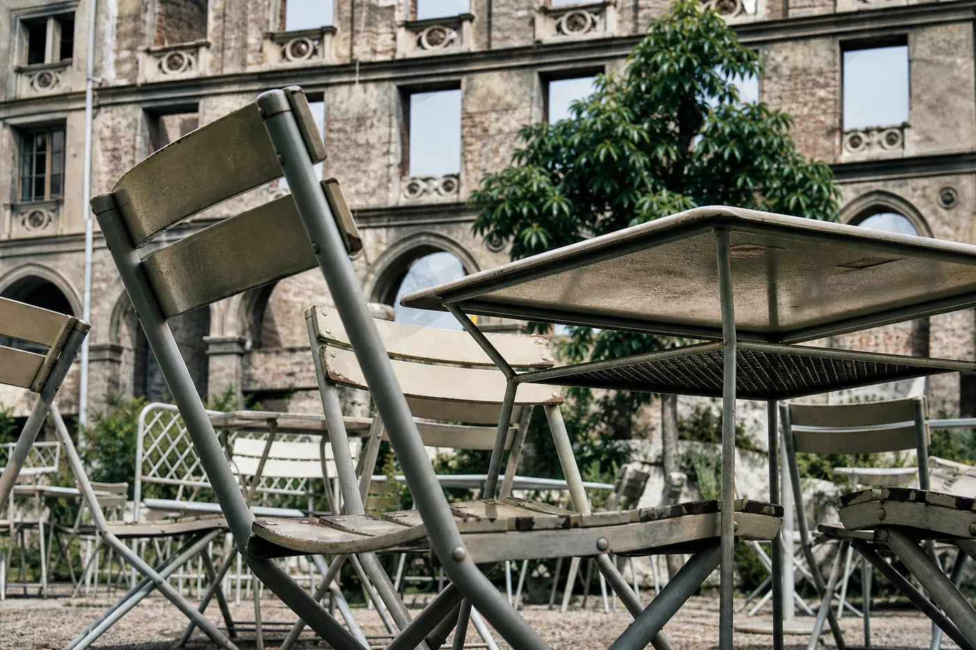 Lokal im Sommer vor einer Ruinenrückwand in München
