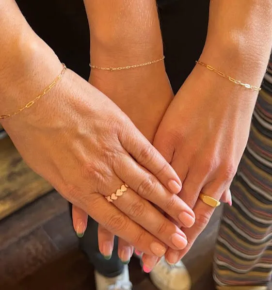 Close-up showcasing various friendship bracelet designs; various metals and charms