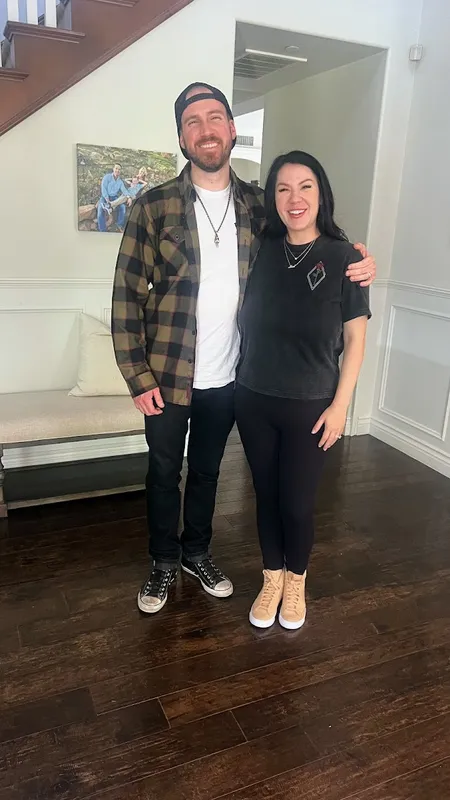 A couple smiling, showcasing their matching permanent bracelets