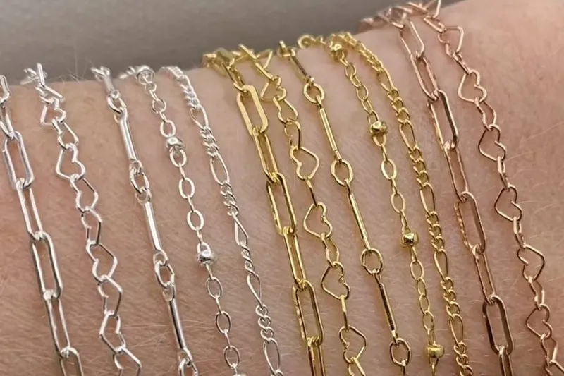 Close-up of hypoallergenic metal options including platinum, gold, and silver chains.