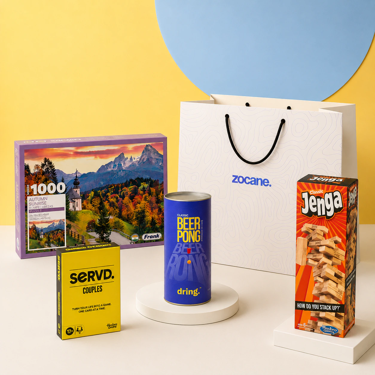 Friends playing cards, a board game, and a stacking game around a snack-filled table